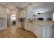 Modern kitchen with white cabinets, stainless steel appliances, and a breakfast bar at 27146 Greenfly Orchid Ln, Leesburg, FL 34748