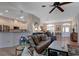 Open-concept living area with tile floors, modern furnishings, and a view to the kitchen at 27146 Greenfly Orchid Ln, Leesburg, FL 34748