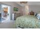 Bright main bedroom with ceiling fan and sliding door access to the outdoors at 27146 Greenfly Orchid Ln, Leesburg, FL 34748