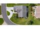 An aerial view of a well-maintained property with lush landscaping and a curved driveway at 2785 Privada Dr, The Villages, FL 32162