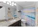 Bathroom with a large vanity and an ocean themed shower curtain at 2785 Privada Dr, The Villages, FL 32162