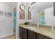 Bathroom featuring granite counters, decorative door and neutral colored walls at 2785 Privada Dr, The Villages, FL 32162