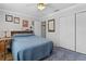 Cozy bedroom with blue carpet, closet and neutral paint at 2785 Privada Dr, The Villages, FL 32162
