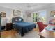 Bedroom featuring a large window, ceiling fan and a queen-size bed at 2785 Privada Dr, The Villages, FL 32162
