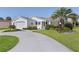 Well-maintained single-story home with a two-car garage and lush landscaping at 2785 Privada Dr, The Villages, FL 32162