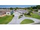 Charming single-story home featuring a well-manicured lawn and a circular driveway at 2785 Privada Dr, The Villages, FL 32162