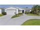 Inviting single-story home with a well-maintained lawn and an attached garage at 2785 Privada Dr, The Villages, FL 32162