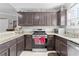 Well-equipped kitchen featuring granite countertops, stainless appliances, and custom cabinetry at 2785 Privada Dr, The Villages, FL 32162