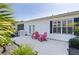 Private patio featuring two red Adirondack chairs and view of the backyard at 2785 Privada Dr, The Villages, FL 32162