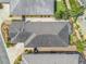 Overhead view of a roof and a backyard with patio furniture and manicured landscaping, offering a private outdoor space at 3074 Eastwood Ter, The Villages, FL 32163