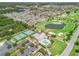 Aerial view showcases residential area nestled beside golf course and community center amenities, perfect for an active lifestyle at 3074 Eastwood Ter, The Villages, FL 32163