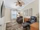 Comfortable space featuring neutral paint, a decorative ceiling fan, and a large leaf-patterned rug at 3074 Eastwood Ter, The Villages, FL 32163