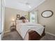 Cozy bedroom featuring plush carpeting, a ceiling fan, and a comfortable bed with decorative pillows and bedside table at 3074 Eastwood Ter, The Villages, FL 32163