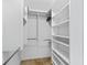 Walk-in closet with built-in shelving and chrome rods to hang clothing. Ample space for organizing your wardrobe at 3074 Eastwood Ter, The Villages, FL 32163
