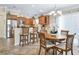 Cozy dining area adjacent to kitchen featuring modern lighting and views of the outdoor living space at 3074 Eastwood Ter, The Villages, FL 32163