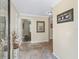 Bright and airy hallway with neutral tones, tile flooring, and decorative wall art creating a welcoming atmosphere at 3074 Eastwood Ter, The Villages, FL 32163