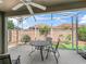 Screened lanai showcasing outdoor seating and a serene view of the backyard, perfect for relaxation and enjoyment at 3074 Eastwood Ter, The Villages, FL 32163