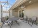 Relaxing screened lanai with a ceiling fan, comfortable seating, and access to the home's interior at 3074 Eastwood Ter, The Villages, FL 32163
