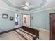 Roomy primary bedroom showcasing a trey ceiling, tiled floors, with easy access to a private bathroom and closet at 3074 Eastwood Ter, The Villages, FL 32163
