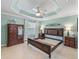 Spacious bedroom with unique tray ceiling, decorative ceiling fan, and neutral paint, awaiting your personal touch at 3074 Eastwood Ter, The Villages, FL 32163