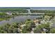 Overhead view of charming homes nestled near a bridge spanning a lake and lush, green surroundings at 31941 Tropical Shores Dr, Tavares, FL 32778