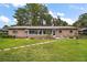 Spacious backyard with a brick home, stepping stone pathway, and a picnic area at 31941 Tropical Shores Dr, Tavares, FL 32778
