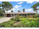 Charming single-story home with well-maintained landscaping and a welcoming entrance at 31941 Tropical Shores Dr, Tavares, FL 32778