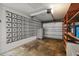 Spacious garage with breezeway block wall, an open garage door, and built-in shelving at 31941 Tropical Shores Dr, Tavares, FL 32778