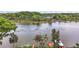 Scenic aerial view showcasing a serene lake bordered by lush trees and waterfront docks at 31941 Tropical Shores Dr, Tavares, FL 32778