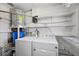 Well-equipped laundry room with washer, dryer, water heater, shelving, and ample storage space at 31941 Tropical Shores Dr, Tavares, FL 32778