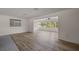 Bright living room features wood-look flooring and a sunroom with expansive windows showcasing the outdoor views at 31941 Tropical Shores Dr, Tavares, FL 32778