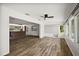 Bright living room showcases wood-look floors connecting to the kitchen and a sunroom with water views at 31941 Tropical Shores Dr, Tavares, FL 32778