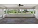 Sunroom boasts large windows offering panoramic views of the lush backyard and waterfront at 31941 Tropical Shores Dr, Tavares, FL 32778