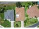 Aerial view of three homes with well-maintained roofs, driveways and yards at 3257 Baltic Sea Blvd, Tavares, FL 32778