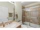 Bathroom with a single sink, a shower, and sliding glass doors at 3257 Baltic Sea Blvd, Tavares, FL 32778