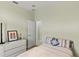 Cozy bedroom with neutral walls, comfortable bed, and chest of drawers at 3257 Baltic Sea Blvd, Tavares, FL 32778