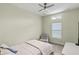 A bedroom with neutral tones, a ceiling fan, a window, and a chair with a TV stand at 3257 Baltic Sea Blvd, Tavares, FL 32778