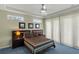 Well-lit bedroom with tray ceiling, ceiling fan, carpeted floor and modern decor at 3257 Baltic Sea Blvd, Tavares, FL 32778