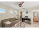 Bonus room with a sofa, desk, ceiling fan, and access to the bathroom and walk-in closet at 3257 Baltic Sea Blvd, Tavares, FL 32778