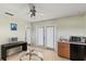 Bonus room with wet bar, desk, ceiling fan, and access to the outdoors at 3257 Baltic Sea Blvd, Tavares, FL 32778