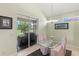 Bright dining area with sliding doors to the patio and a modern chandelier at 3257 Baltic Sea Blvd, Tavares, FL 32778