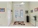 Bright entryway with tiled floors, decorative glass double doors, and transom window at 3257 Baltic Sea Blvd, Tavares, FL 32778