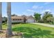Charming home featuring a lush green lawn and well-manicured landscaping at 3257 Baltic Sea Blvd, Tavares, FL 32778