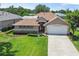 Charming single-story home showcasing a well-manicured lawn and a two-car garage at 3257 Baltic Sea Blvd, Tavares, FL 32778
