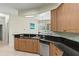 Well-equipped kitchen with stainless dishwasher, dark granite and beautiful cabinets at 3257 Baltic Sea Blvd, Tavares, FL 32778