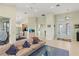 Bright living room with tile floors and an open layout connecting to dining and kitchen at 3257 Baltic Sea Blvd, Tavares, FL 32778