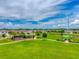 Aerial view showcases a neighborhood park with walking paths, a playground, and a covered picnic area on a sunny day at 33960 Sky Blossom Cir, Leesburg, FL 34788