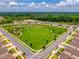 Wide aerial view of the neighborhood showcasing a large green space and surrounding residential area at 33960 Sky Blossom Cir, Leesburg, FL 34788