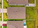 Overhead view displays the roofs of homes, backyards with fences and patios, and neatly arranged landscaping at 33960 Sky Blossom Cir, Leesburg, FL 34788