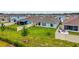 Aerial view of the property showing the backyard, patio, and the surrounding neighborhood at 33960 Sky Blossom Cir, Leesburg, FL 34788